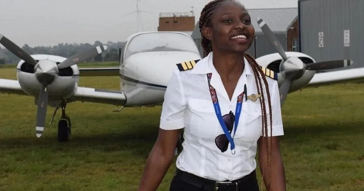 Audrey Maame Esi Swatson, Ghana's youngest female pilot, in pilot uniform by an aircraft