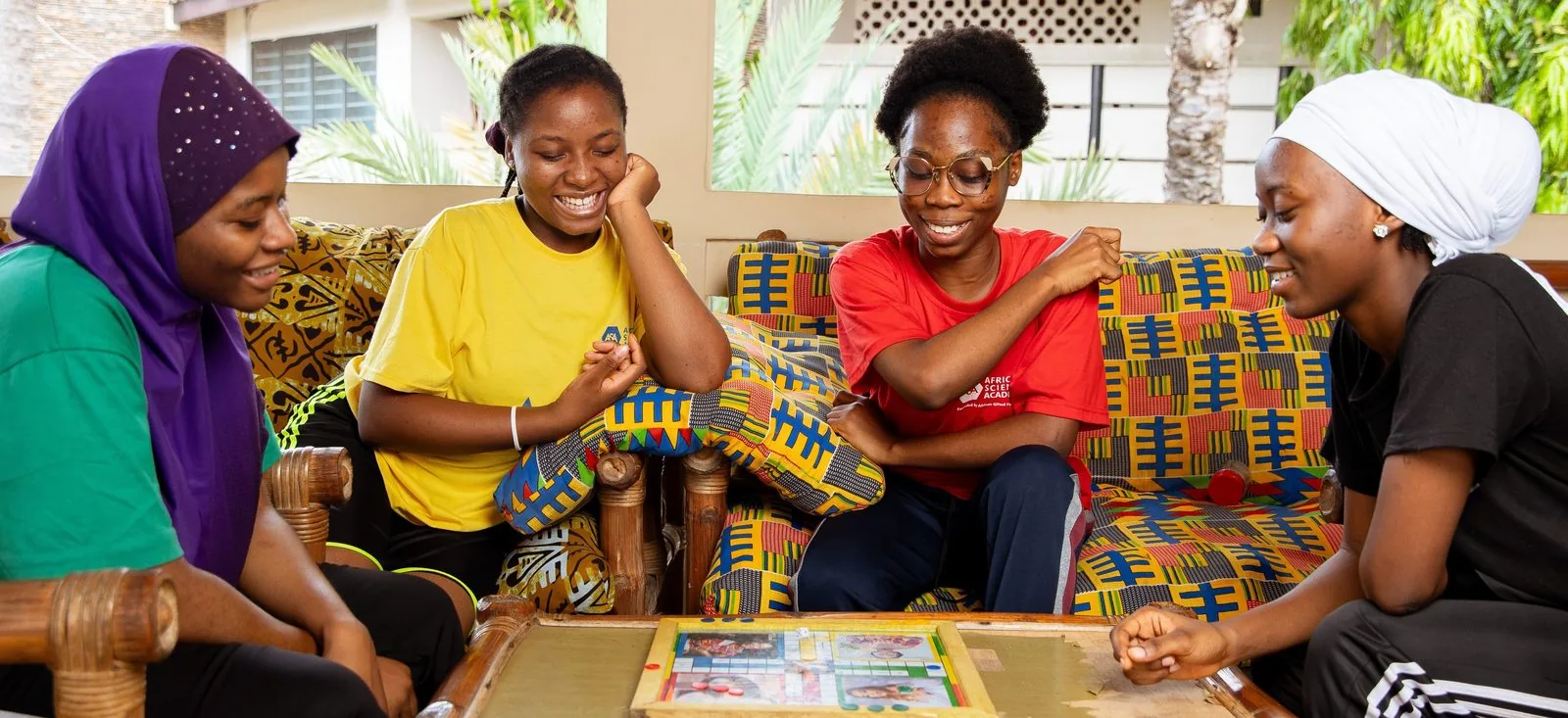 ASA students laughing together over a board game