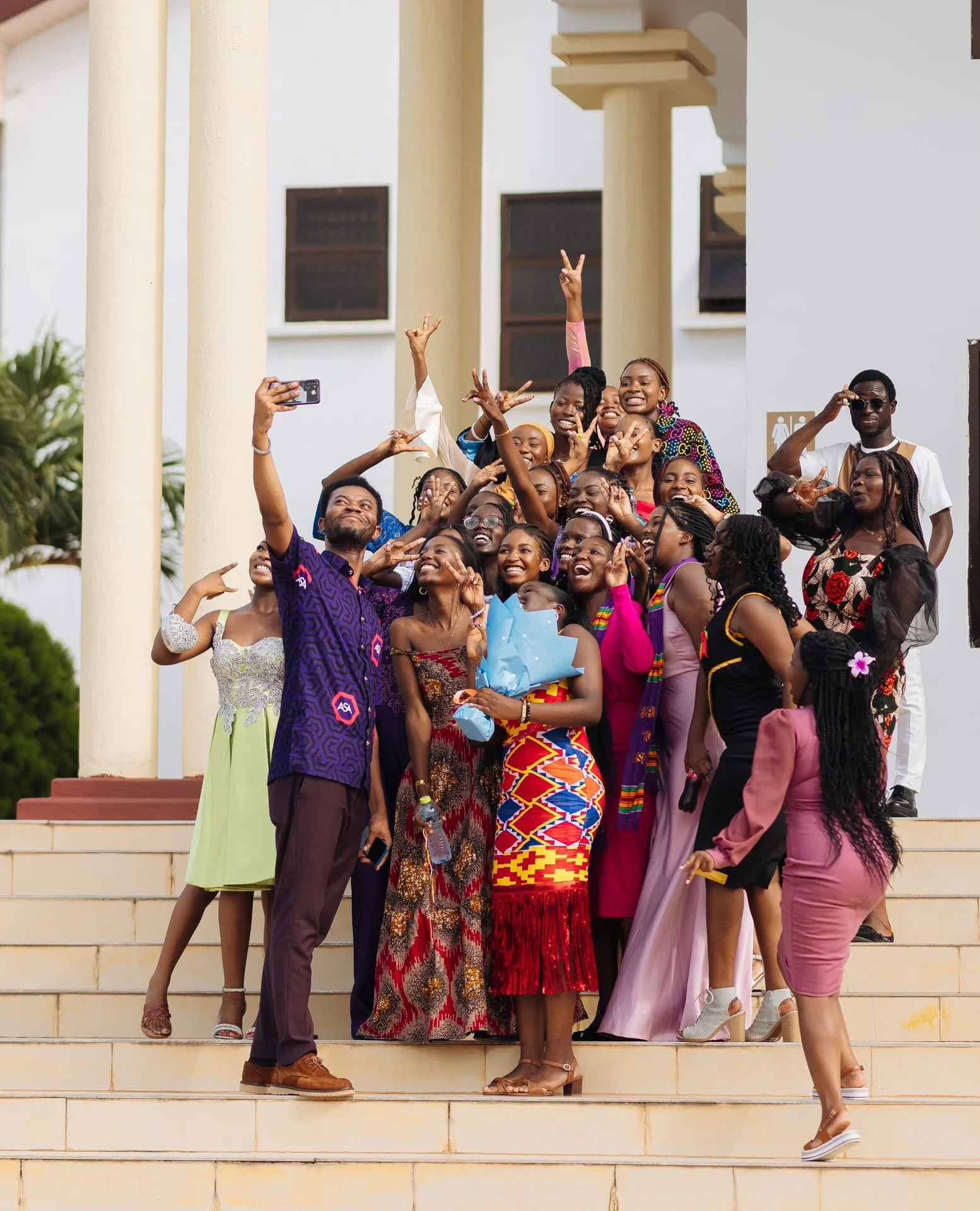 ASA students and staff posing for a group selfie on the steps