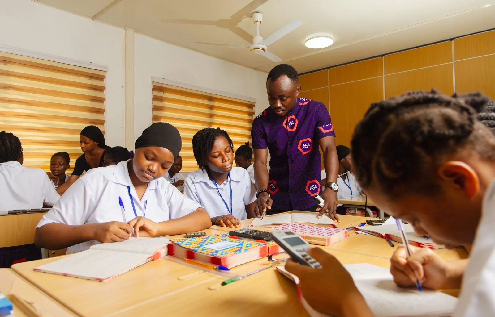 ASA teacher overseeing students working at their desks