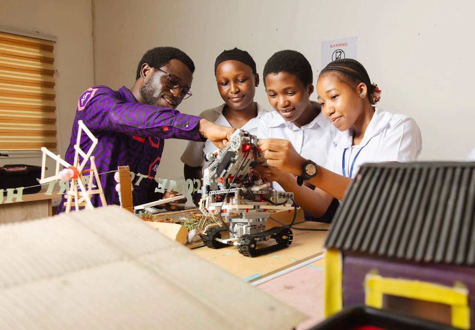 ASA teacher and students building robots in the robotics lab