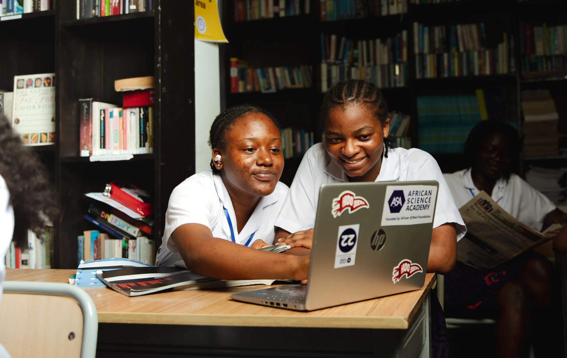 Two ASA students studying together with a laptop in the library